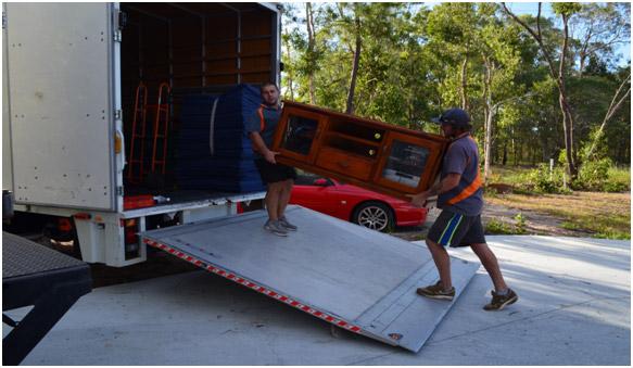 Two professional removalists loading one of our removal trucks in Brisbane
